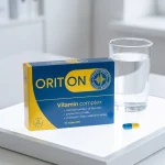 Cápsula de Oriton junto a un vaso de agua para la toma diaria
